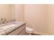 Powder room with granite countertop and commode at 208 Crabapple St, Mcdonough, GA 30253