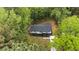 Aerial view showcasing the charming home's exterior, surrounded by lush greenery and a well-maintained yard at 2798 Hutchins Rd, Lawrenceville, GA 30044