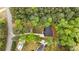 Birds eye view of a well-maintained property featuring a grey roof, a new driveway, and mature trees at 2798 Hutchins Rd, Lawrenceville, GA 30044