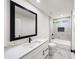 Modern bathroom featuring marble tile, sleek black fixtures, and a shower-tub combination at 2798 Hutchins Rd, Lawrenceville, GA 30044