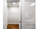 Walk-in closet featuring hardwood floors and ample storage space with a sliding door for easy access at 2798 Hutchins Rd, Lawrenceville, GA 30044