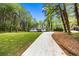 Charming home featuring a well-manicured front lawn, lengthy concrete driveway, and a tranquil setting at 2798 Hutchins Rd, Lawrenceville, GA 30044