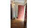 Inviting foyer with hardwood floors, decorative lighting, and a striking red front door at 2912 Pathview Ln, Marietta, GA 30062