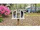 A book sharing box sits on the lawn of a blue home at 2912 Pathview Ln, Marietta, GA 30062