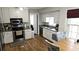 Bright kitchen features stainless steel appliances, white cabinets, and hardwood floors at 2912 Pathview Ln, Marietta, GA 30062