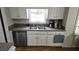Classic kitchen featuring white cabinets, stainless steel sink, and appliances at 2912 Pathview Ln, Marietta, GA 30062