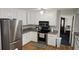 Kitchen with stainless steel appliances, white cabinets, and open floor plan at 2912 Pathview Ln, Marietta, GA 30062