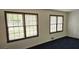Bright living room with blue carpet and natural light from two windows at 2912 Pathview Ln, Marietta, GA 30062