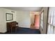 Cozy living room with blue carpet, and a red front door at 2912 Pathview Ln, Marietta, GA 30062