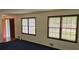 Cozy living room with blue carpet, and a red front door at 2912 Pathview Ln, Marietta, GA 30062