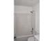 Bathroom features a bathtub with white surround and shower, and a toilet at 6737 Mason Creek Rd, Douglasville, GA 30135