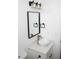Bathroom features a white bowl sink, black hardware, and an elegant black-framed mirror at 6737 Mason Creek Rd, Douglasville, GA 30135
