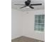 Bedroom featuring light-colored walls, ceiling fan, window overlooking the backyard, and wood-look floors at 6737 Mason Creek Rd, Douglasville, GA 30135