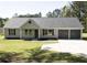 Charming single-story home featuring a well-manicured lawn and an attached two-car garage at 6737 Mason Creek Rd, Douglasville, GA 30135
