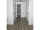 Hallway featuring wood-look flooring, neutral paint, and classic white doors to various rooms at 6737 Mason Creek Rd, Douglasville, GA 30135