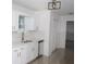 Well-lit kitchen with white cabinets, marble-look backsplash, quartz countertops, and modern faucet at 6737 Mason Creek Rd, Douglasville, GA 30135