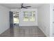 Bright living room features a ceiling fan, wood-look flooring, and a window with natural light at 6737 Mason Creek Rd, Douglasville, GA 30135