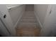 Stairwell with neutral carpet and white walls leading to another level at 6737 Mason Creek Rd, Douglasville, GA 30135