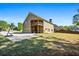 View of a spacious backyard with lush green grass and a two-story home with a balcony at 1041 Sweetwater Bridge Cir, Douglasville, GA 30134