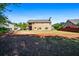 A spacious backyard with lush green grass and a two-story home with a balcony at 1041 Sweetwater Bridge Cir, Douglasville, GA 30134