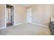 Bedroom showcasing neutral walls, plush carpeting, and access to an en-suite bathroom at 1041 Sweetwater Bridge Cir, Douglasville, GA 30134
