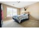 Bright bedroom with plush carpet, natural light, and neutral colored walls at 1041 Sweetwater Bridge Cir, Douglasville, GA 30134
