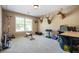 Spacious bonus room is carpeted and provides ample space for gym equipment, with natural light from the bright window at 1041 Sweetwater Bridge Cir, Douglasville, GA 30134