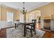 Formal dining room with stylish lighting, wainscoting, and hardwood flooring at 1041 Sweetwater Bridge Cir, Douglasville, GA 30134