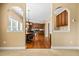 Dining room with hardwood floors, view of kitchen, arched doorways at 1041 Sweetwater Bridge Cir, Douglasville, GA 30134
