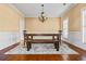 Formal dining room with stylish lighting, wainscoting, and hardwood flooring at 1041 Sweetwater Bridge Cir, Douglasville, GA 30134