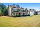 Beautiful two-story home featuring manicured lawn, lush landscaping, and inviting front porch at 1041 Sweetwater Bridge Cir, Douglasville, GA 30134