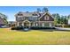 Charming two-story home with a well-maintained lawn and a classic design at 1041 Sweetwater Bridge Cir, Douglasville, GA 30134