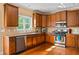 Kitchen boasts stainless steel appliances, granite counters, and wood cabinets at 1041 Sweetwater Bridge Cir, Douglasville, GA 30134