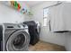 Laundry room featuring modern washer and dryer with shelving for storage at 1041 Sweetwater Bridge Cir, Douglasville, GA 30134