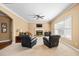 Cozy living room features a stone fireplace, ceiling fan, and large window at 1041 Sweetwater Bridge Cir, Douglasville, GA 30134