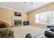 Bright living room boasts a stone fireplace, large windows and plush carpet at 1041 Sweetwater Bridge Cir, Douglasville, GA 30134