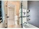 Bathroom featuring a tub with tiled walls, shelving units and a large mirror above a sleek vanity at 301 10Th Ne St # 3, Atlanta, GA 30309