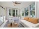 Bright bedroom with large windows, neutral decor, and a modern ceiling fan at 301 10Th Ne St # 3, Atlanta, GA 30309