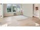 Bright and airy living room with large windows, light hardwood flooring, and simple decor at 301 10Th Ne St # 3, Atlanta, GA 30309