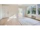 A view of the bright living room, showing the large windows and light hardwood flooring at 301 10Th Ne St # 3, Atlanta, GA 30309