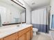 Bathroom featuring a large mirror, vanity with cabinets, a toilet, and a shower-tub combination at 3501 Chattahoochee Summit Se Ln, Atlanta, GA 30339