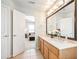 Bathroom with double sinks, a large mirror, and an open doorway to a bedroom space at 3501 Chattahoochee Summit Se Ln, Atlanta, GA 30339