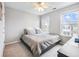 Cozy bedroom featuring a low-profile bed, two windows, and neutral colored walls and carpeting at 3501 Chattahoochee Summit Se Ln, Atlanta, GA 30339