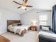 Comfortable carpeted bedroom with natural light, a ceiling fan, and an adjacent seating area at 3501 Chattahoochee Summit Se Ln, Atlanta, GA 30339
