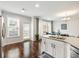 Bright kitchen with granite counters, white cabinets and hardwood floors at 3501 Chattahoochee Summit Se Ln, Atlanta, GA 30339