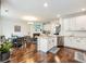 Open kitchen features white cabinets, granite countertops, stainless steel appliances, and hardwood floors at 3501 Chattahoochee Summit Se Ln, Atlanta, GA 30339