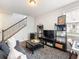 Comfortable living room boasts stylish furniture, a chic rug, and staircase access for convenient living at 3501 Chattahoochee Summit Se Ln, Atlanta, GA 30339