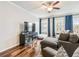 Bright living room with hardwood floors, blue curtains and an entertainment center at 3501 Chattahoochee Summit Se Ln, Atlanta, GA 30339