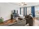 Bright living room with hardwood floors, blue curtains and an entertainment center at 3501 Chattahoochee Summit Se Ln, Atlanta, GA 30339
