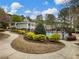 Community pool with lounge chairs, meticulous landscaping, and clubhouse in the background at 3501 Chattahoochee Summit Se Ln, Atlanta, GA 30339
